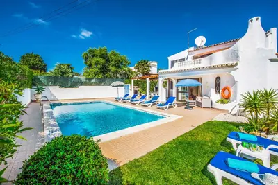 a villa with a swimming pool in a yard at Villa Miramar in Albufeira