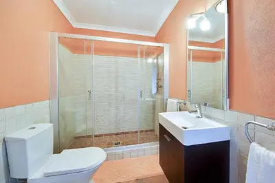 a bathroom with a toilet and a sink and a shower at Villa Monte de Madrinha in Albufeira
