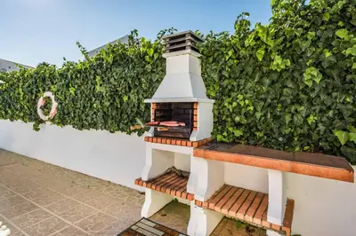 a small lighthouse sitting on a bench next to a hedge at Villa Lourenco in Albufeira