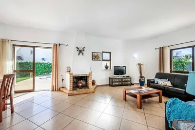 a living room with a couch and a fireplace at Villa Lourenco in Albufeira
