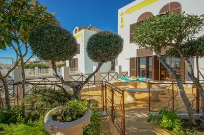 a patio with trees in front of a building at Villa Albuar in Albufeira