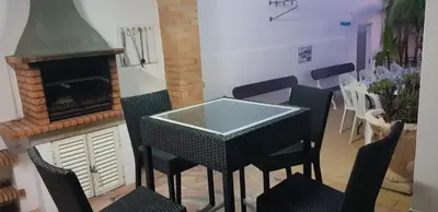 a dining room with a table and chairs and a fireplace at Villa Albuar in Albufeira
