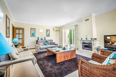 a living room filled with furniture and a fireplace at Villa Altair in Albufeira