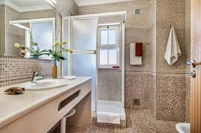 a bathroom with a sink and a shower at Villa Altair in Albufeira