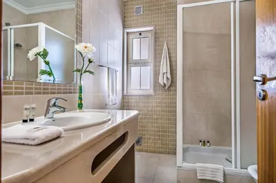 a bathroom with a sink and a shower at Villa Altair in Albufeira