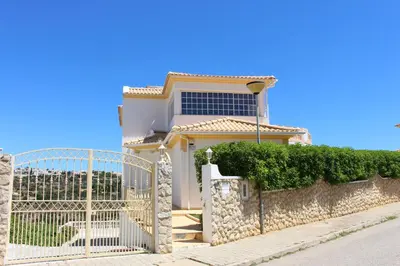 a house with a gate in front of it at Villa Sunny in Albufeira