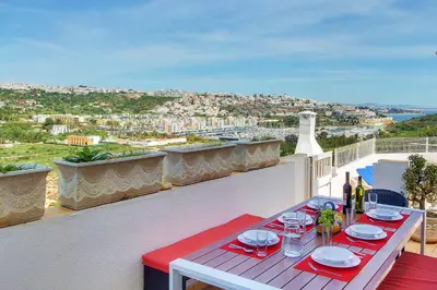 a table on a balcony with a view of a city at Villa Sunny in Albufeira