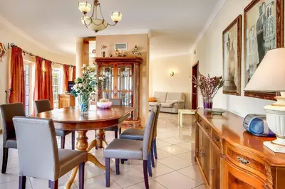 a dining room with a wooden table and chairs at Villa Sunny in Albufeira