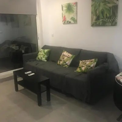 a kitchen with white cabinets and a black appliance at Rua José Afonso in Albufeira
