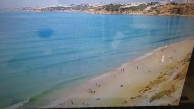 a view of a beach with people in the water at Casa Boneca - Aldeia das Açoteias in Albufeira