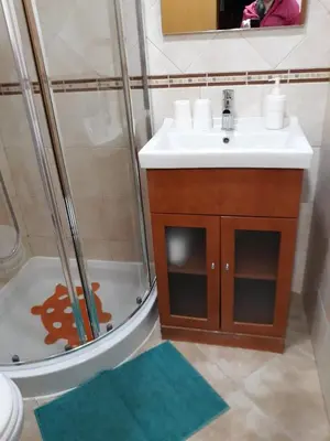 a bathroom with a shower and a sink and a mirror at Casa Boneca - Aldeia das Açoteias in Albufeira