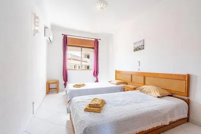 a bedroom with two beds and a window at Apartamentos Old Town by Umbral in Albufeira