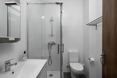 a bathroom with a shower and a toilet and a sink at Casa Mina in Faro