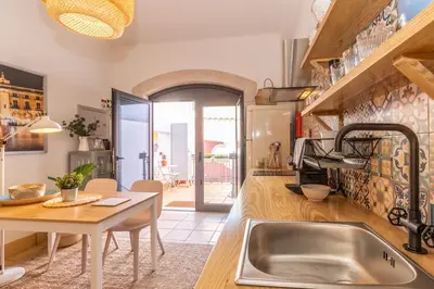 a kitchen with a sink and a table at FARO DOWNTOWN STUDIOS in Faro