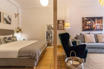 a bedroom with a bed and a couch at FARO DOWNTOWN STUDIOS in Faro