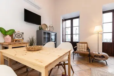 a living room with a wooden table and chairs at FARO DOWNTOWN STUDIOS in Faro