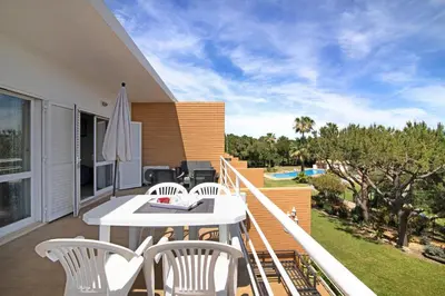 a patio with a table and chairs on a balcony at Yara Beach Apartments with Terrace in Albufeira