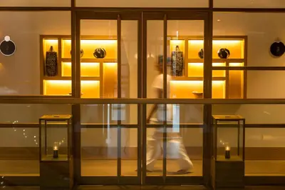 a person walking through a store window with candles at EPIC SANA Algarve Hotel in Albufeira