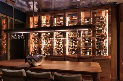 a dining room with a table and a wine cellar at EPIC SANA Algarve Hotel in Albufeira