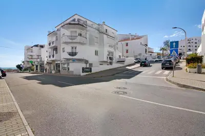 a street with a white building on the side of the road at City Center Albufeira in Albufeira