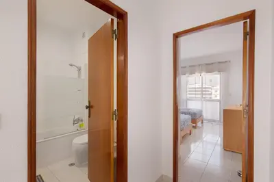 a bathroom with a toilet and a mirror at City Center Albufeira in Albufeira