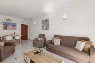 a living room with two couches and a table at City Center Albufeira in Albufeira