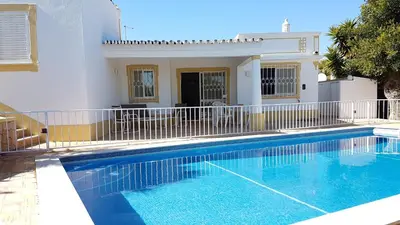 a swimming pool in front of a house at Casa Dos Cedros in Guia