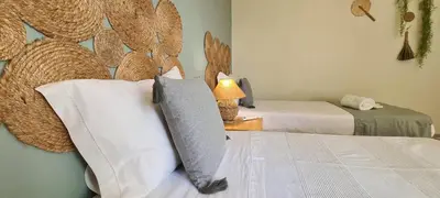 a room with two beds and a lamp on a table at Casa Dos Cedros in Guia