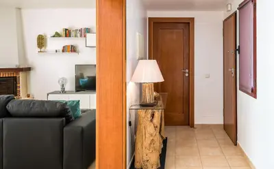 a living room with a couch and a lamp at Vilasol apartment by Intiholidays in Vilamoura