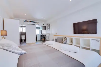 a living room with a couch and a flat screen tv at À da Avó -The Guesthouse in Faro