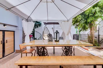 a dining room with a table and a tent at À da Avó -The Guesthouse in Faro