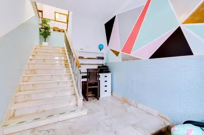 a staircase in a room with a desk and a wall at À da Avó -The Guesthouse in Faro