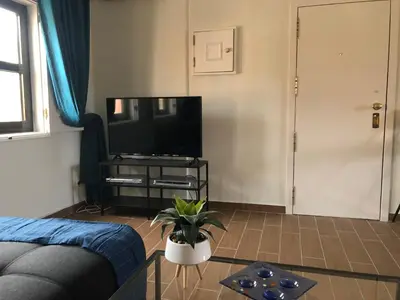 a living room with a couch and a flat screen tv at Vilamoura 2 bed new apartment in Vilamoura
