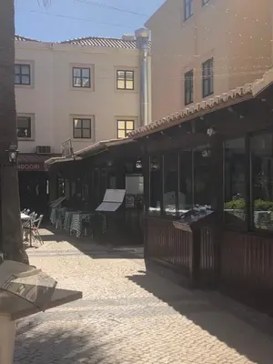 a building with a restaurant with tables and chairs at Vilamoura 2 bed new apartment in Vilamoura