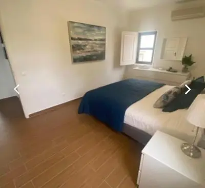a bedroom with a bed and a table with a lamp at Vilamoura 2 bed new apartment in Vilamoura