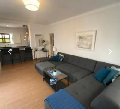 a living room with a couch and a table at Vilamoura 2 bed new apartment in Vilamoura