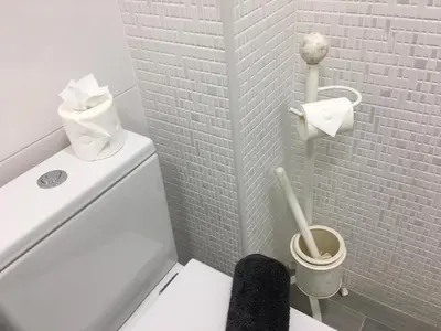 a white bathroom with a toilet with a toilet brush at Vilamoura Apartment in Quarteira