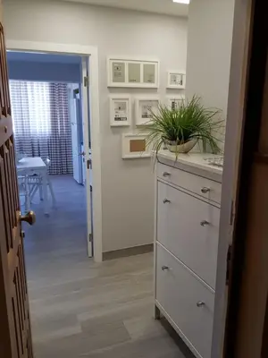 a kitchen with a dresser with a plant on it at Vilamoura Apartment in Quarteira