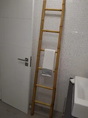 a wooden ladder in a bathroom with a towel at Vilamoura Apartment in Quarteira