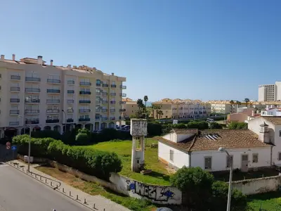 a view of a city with a building and a street at Vilamoura Apartment in Quarteira