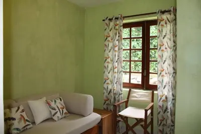 a living room with a couch and a window at Vila 67 in Albufeira