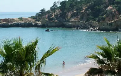 a person standing in the water on a beach at Vila 67 in Albufeira