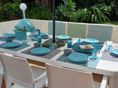 a white table with blue plates on it at Vila 67 in Albufeira