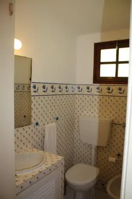 a bathroom with a toilet and a sink at Vila 67 in Albufeira