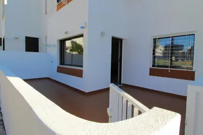 a white house with a staircase and windows at Apartamento das Oliveiras in Albufeira