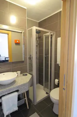 a bathroom with a shower and a toilet and a sink at Apartamento das Oliveiras in Albufeira