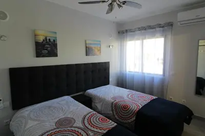 a bedroom with a bed and a ceiling fan at Apartamento das Oliveiras in Albufeira