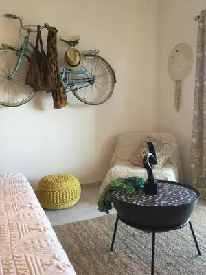 a living room with a bike hanging on the wall at Chambre d Hôte exclusif Naturiste et Nudiste CASA AMSYL adultes only in Paderne