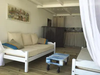 a living room with a couch and a table at Chambre d Hôte exclusif Naturiste et Nudiste CASA AMSYL adultes only in Paderne