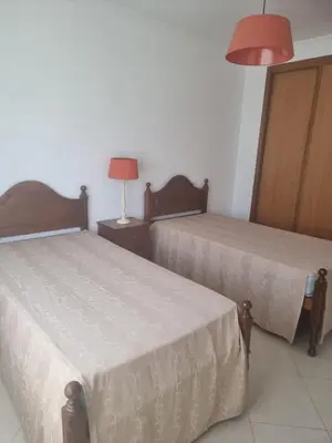 a room with two beds and a lamp at Albufeira Apart. T2 Baixa in Albufeira